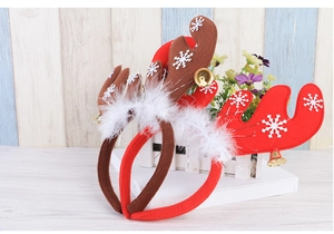 Detail of Christmas reindeer antlers headband with snowy flakes, feathers, and golden bells