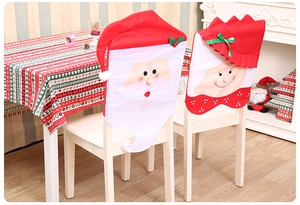 Detail of Santa Claus and elf non-woven chair covers for Christmas table decoration