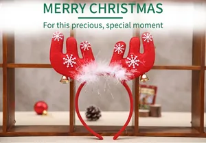 Detail view of red Christmas reindeer antler headband with bells and white feathers
