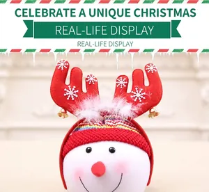 Detail of Christmas reindeer antler headband with white snowflakes and gold bells
