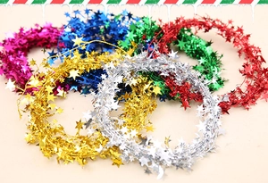 Detailed view of colorful metallic star tinsel garlands for Christmas tree decoration