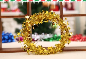 Close-up of golden Christmas star garland decoration on a festive wooden background