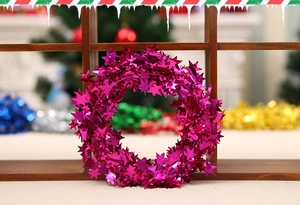 Macro view of metallic rose red star garland decoration for Christmas festive celebrations