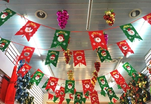 Detail of red and green felt Christmas banners with Merry Christmas text and cartoon patterns