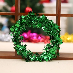 7.5m green Christmas star tinsel garland with metallic glitter on a festive wooden background