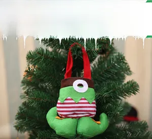 Close-up of a festive Christmas elf candy bag with red stripes on a green pine tree branch