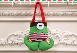 Detail of Christmas elf pants candy bag with green fabric and red striped suspender handles