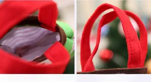 Detail of red felt Christmas gift bag showing thick handle and striped inner lining