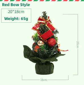 Detailed view of a 20cm mini Christmas tree with red bows and festive ornaments