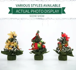 Three 20cm mini Christmas trees with gold flowers, red bows and snowy finish detail