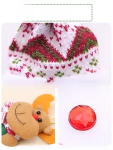Detail of Christmas ornament featuring knitted fabric, reindeer felt, and red gemstone charm