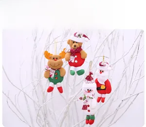 Detailed view of four plush Christmas ornaments hanging on white branches with gold strings