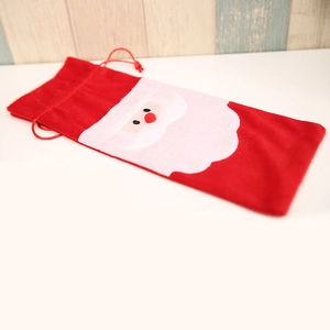 Red velvet Santa Claus wine bottle gift bag with white beard and drawstring closure