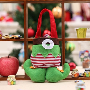 Christmas elf style felt candy gift bag with red and green stripe design on wooden rack
