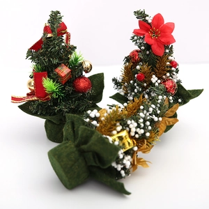 Three-piece mini tabletop Christmas trees with red bows and gold bells on a white background