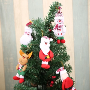 Christmas hanging ornaments featuring Santa, snowman, and reindeer on a festive tree branch