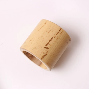 Natural handmade bamboo napkin ring with authentic texture on a clean white background
