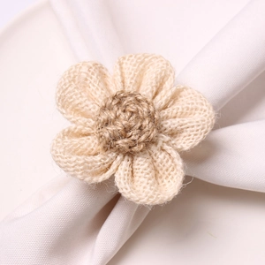 Detailed close-up of handmade raffia sunflower napkin ring with woven fiber textures