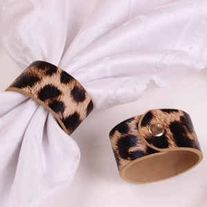 Leopard print leather napkin rings with gold metal button clasp for dining decor
