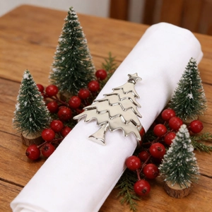 Silver Christmas tree napkin ring on white cloth with festive holiday table decor