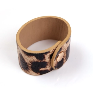 Close-up of leopard print leather bracelet with rose gold metal snap buckle detail