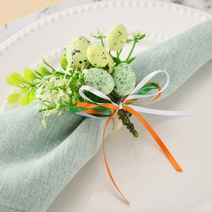 Detail of Easter napkin ring with speckled eggs, wood base and green ribbon bow