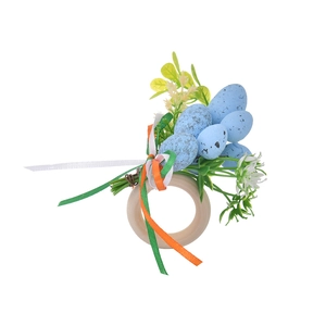 Detail of Easter napkin ring with speckled eggs, wooden loop and colorful ribbons
