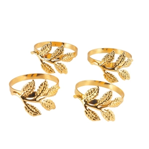Set of four gold leaf-shaped metal napkin rings with intricate vein details on white background