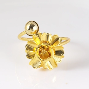 Detailed macro of golden butterfly napkin ring with double-layer metal flower texture