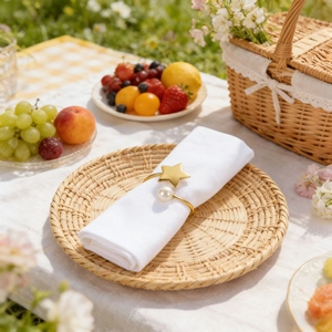 Golden star and pearl napkin ring on a yellow checkered tablecloth for outdoor dining