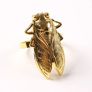 Elegant gold cicada napkin ring with intricate wing detail for luxury table decor