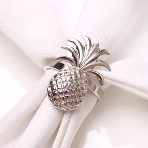 Close-up of polished silver pineapple napkin ring with intricate mesh textures