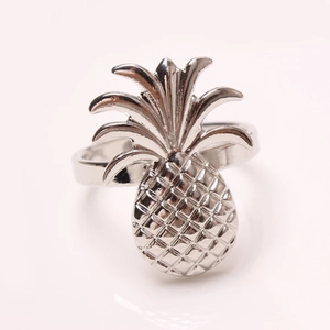 Golden pineapple napkin ring with textured grid pattern for elegant dining table decor