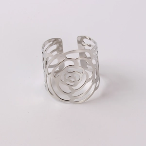 Detailed view of silver hollow rose pattern napkin ring with fine cutout metal texture