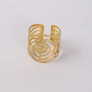 Macro detail of gold plated rose napkin ring featuring hollow layered flower petals