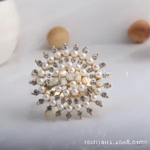 Detail of sunflower shaped pearl napkin ring with rhinestones on a gold metal frame