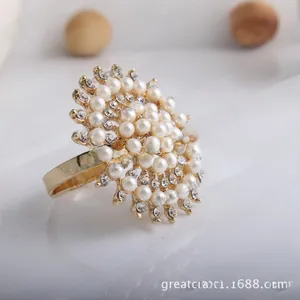 Macro detail of luxury sunflower napkin ring with clustered pearls and sparkling crystals