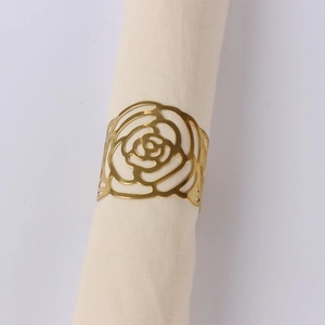 Macro shot of gold-plated rose napkin ring with intricate hollowed-out metal details