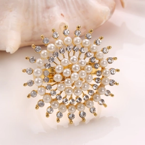 Detailed view of a golden sunflower napkin ring featuring layered pearls and crystals