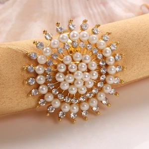 Elegant gold metal sunflower napkin ring with white pearls and sparkling rhinestones