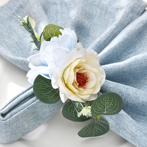 Artificial rose and peony napkin ring with soft blue and yellow petals and green leaves