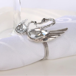 Elegant silver swan napkin ring with sparkling crystals on a white fabric napkin