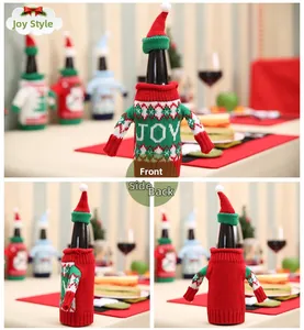 Detail view of knitted Christmas wine bottle sweater with JOY text and matching hat