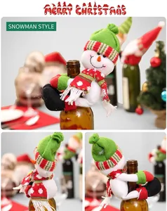 Detail of Christmas snowman wine bottle cover with green knitted hat and striped scarf