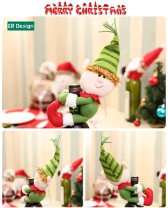 Detail of Christmas elf wine bottle cover with red and green striped hat in home setting
