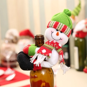 Plush snowman Christmas wine bottle holder with knitted hat and scarf for festive table decor