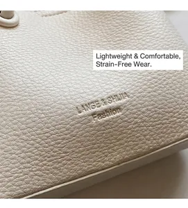 Close-up of beige pebble grain leather texture with embossed fashion logo and fine stitching