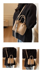 Detail of beige bucket bag featuring lychee texture leather and striped silk scarf decor