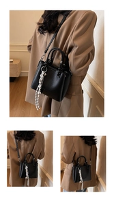 Detail view of black lychee grain mini handbag with decorative black and white silk scarf