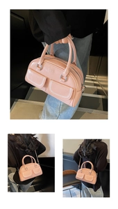 Detail of dusty pink crossbody boston bag with twin front pockets and silver hardware